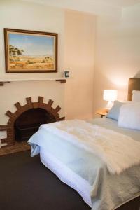 a bedroom with a large bed and a fireplace at Hanisch Haus in Tanunda