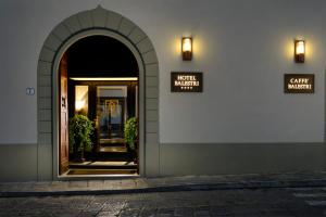 
a building with a clock on the side of it at Hotel Balestri - WTB Hotels in Florence
