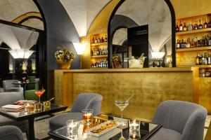 a restaurant with two tables and chairs and a bar at Hotel Balestri - WTB Hotels in Florence