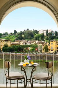 a table with two chairs and a table with a view at Hotel Balestri - WTB Hotels in Florence