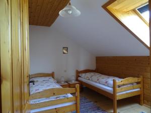 a bedroom with two beds and a window at Baby- und Kinderhof Aicherbauer in Seeham