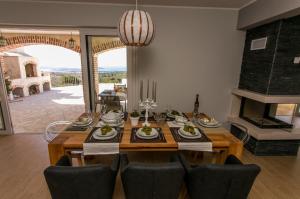 a dining room with a table and a fireplace at Villa Terra Rogoznica in Rogoznica