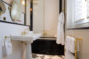 a bathroom with a sink and a mirror at Relais Christine in Paris