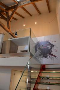 a staircase in a building with a painting on the wall at Maison am Liesingbach in Vienna