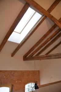 a skylight in the ceiling of a room with wooden beams at Maison am Liesingbach in Vienna