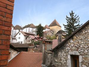 a view of a town from the roofs of buildings at Folk Loft in Annecy