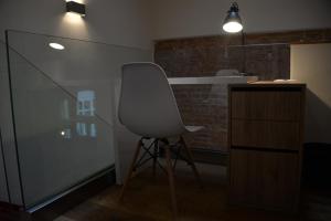 a white chair in a room with a counter at Maison am Liesingbach in Vienna