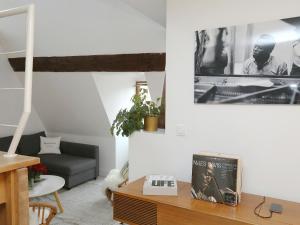 a living room with a couch and a table at Folk Loft in Annecy
