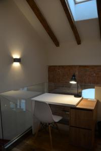 a kitchen with a white desk and a chair at Maison am Liesingbach in Vienna