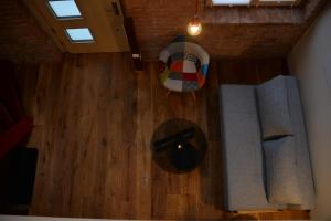 an overhead view of a living room with wood floors at Maison am Liesingbach in Vienna