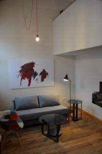 a living room with a couch and a table at Maison am Liesingbach in Vienna