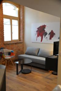 a living room with a couch and a table at Maison am Liesingbach in Vienna