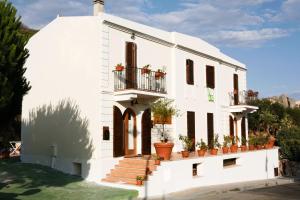 a white house with potted plants on it at Casa Gallasso in Santa Teresa Gallura