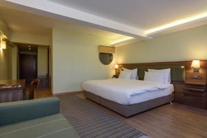 Postel nebo postele na pokoji v ubytování Numi Hotel