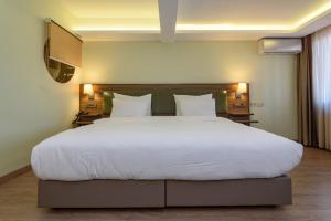 Postel nebo postele na pokoji v ubytování Numi Hotel