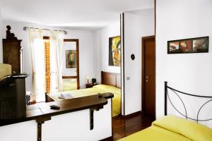 a bedroom with two beds and a desk and a mirror at Casa Gallasso in Santa Teresa Gallura