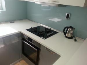 a kitchen with a stove top oven in a counter at Apartments Roncevic in Zadar