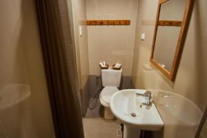 a bathroom with a toilet and a sink and a mirror at Amakan - El Nido Palawan in El Nido