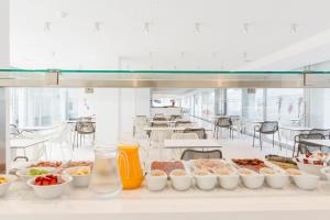 a buffet line with many different types of food at Ebano Hotel Apartments & Spa in Playa d'en Bossa