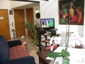 a living room with a couch and a tv at B&B Macalube Aragona in Aragona