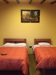 Postel nebo postele na pokoji v ubytování Rumi Sonqo Hostel