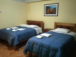 Postel nebo postele na pokoji v ubytování Rumi Sonqo Hostel