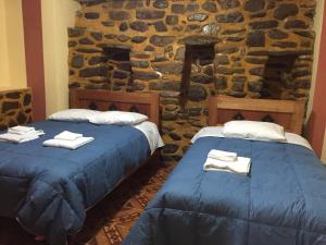 Postel nebo postele na pokoji v ubytování Rumi Sonqo Hostel
