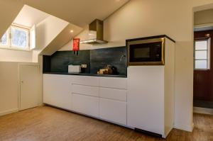 A cozinha ou kitchenette de Ribeira Cinema Apartments