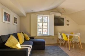 a living room with a couch and a table at Ribeira Cinema Apartments in Porto