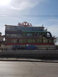a hotel with two cars parked in front of it at Brani Family Hotel in Ruse