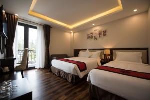 Postel nebo postele na pokoji v ubytování Sapa Wings Hotel