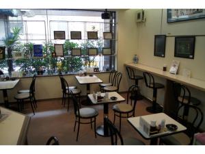 a dining room with tables and chairs in a restaurant at Nishishinjuku Green Hotel in Tokyo