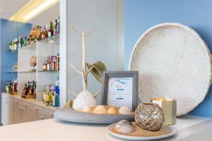 a counter with shells and a picture on it at Palmares Beach House Hotel - Adults Only in Lagos