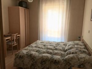 מיטה או מיטות בחדר ב-Garnì Serena
