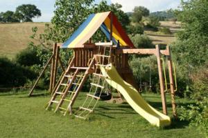 a playground with a slide in the grass at Agriturismo la Gioia in Scansano