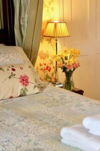 A bed or beds in a room at The Old Vicarage 