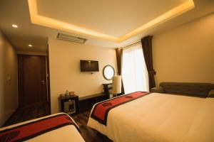Postel nebo postele na pokoji v ubytování Sapa Wings Hotel