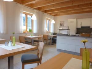 a kitchen and dining room with tables and chairs at Gästehaus Lodermeier in Bad Abbach