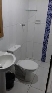 a bathroom with a toilet and a shower and a sink at Hotel Michel in São Paulo