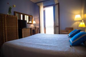 Postel nebo postele na pokoji v ubytování Hotel Cetarium