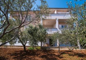 a building with trees in front of it at B&B Villa Ana in Krk