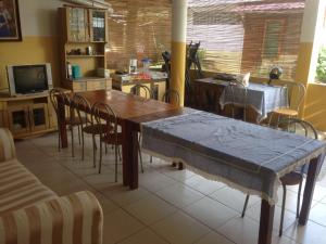 a dining room with a wooden table and chairs at Vila Bemori in Dili