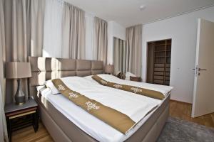 Voodi või voodid majutusasutuse Exklusive Ferienwohnung Villach City toas