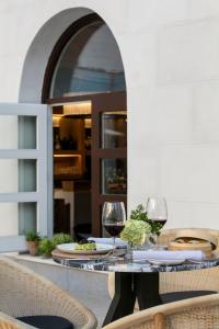 a table with two glasses of wine on it at Palacio de los Duques Gran Meliá - The Leading Hotels of the World in Madrid