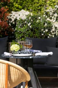 a table with two glasses of wine on it at Palacio de los Duques Gran Meliá - The Leading Hotels of the World in Madrid