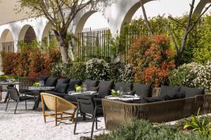 a restaurant with tables and chairs in a courtyard at Palacio de los Duques Gran Meliá - The Leading Hotels of the World in Madrid