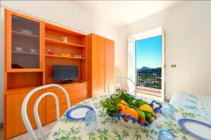 a kitchen with a table with a bowl of fruit on it at Villa Angela Apartment in Ischia Town