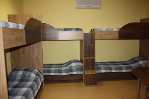 a room with three bunk beds in a room at Solnechny hotel in Dnipro