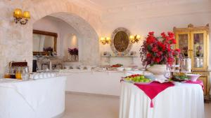 a kitchen with a table with fruits and flowers on it at Lukka Exclusive Hotel – Adult Only +12 in Kaş