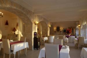 a dining room with white tables and white chairs at Lukka Exclusive Hotel – Adult Only +12 in Kaş
